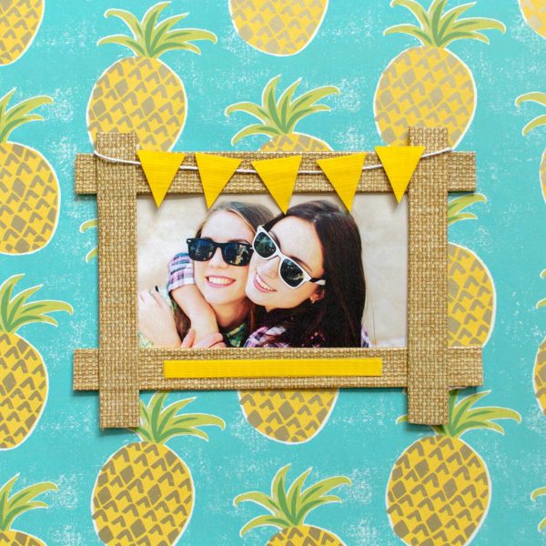 A frame decorated with pineapples and steal duck tape.