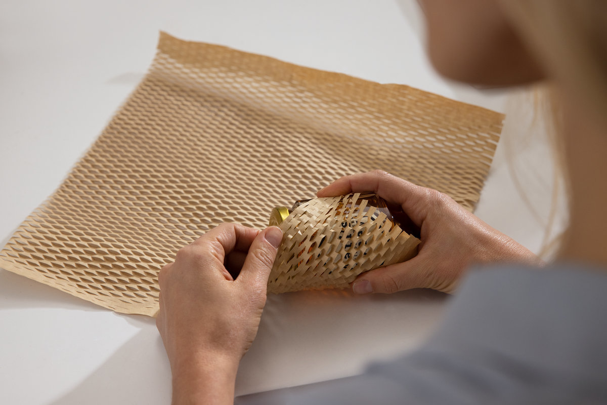 Glass jar being wrapped in Flourish Honeycomb Cushion Wrap