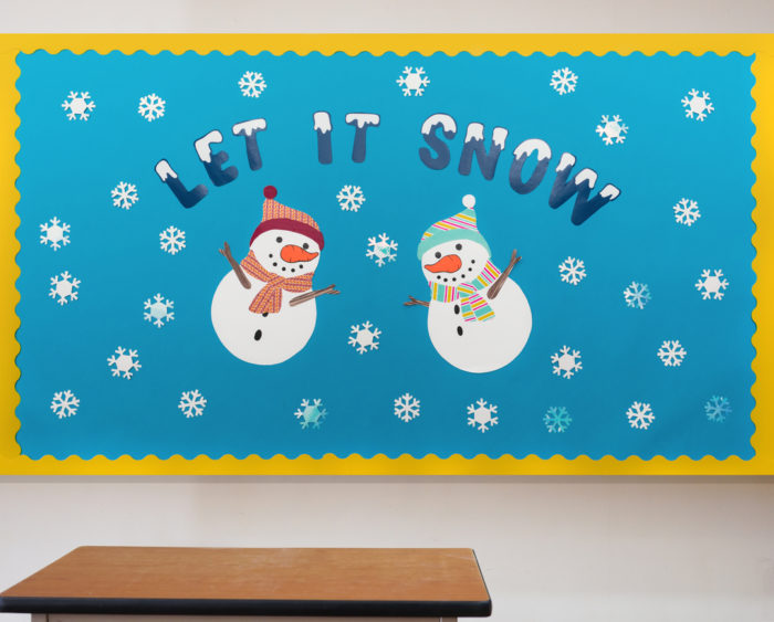 A bulletin board with two snowmen
