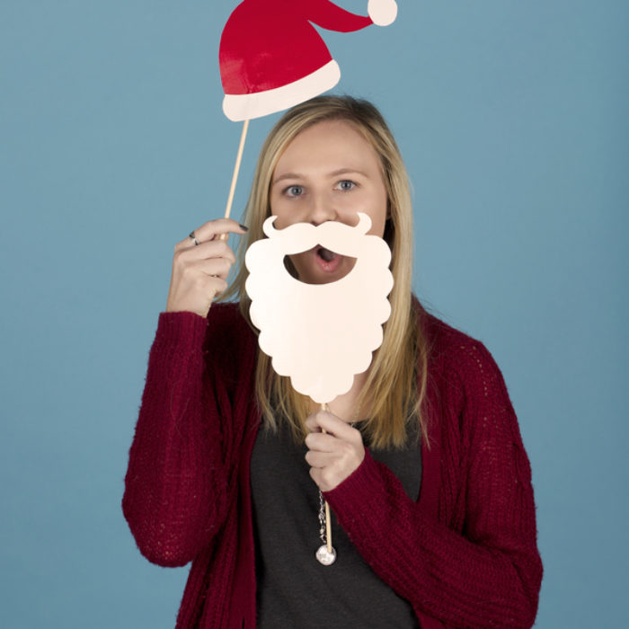 Woman posing with photo booth props of a Santa hat and beard made from Duck Tape