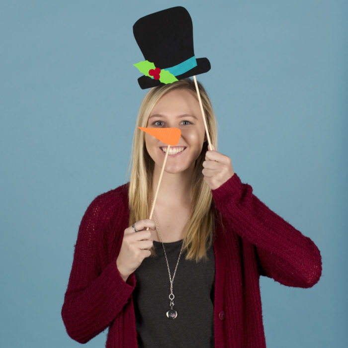 Woman posing with a har and carrot nose  photo booth props made from Duck Tape