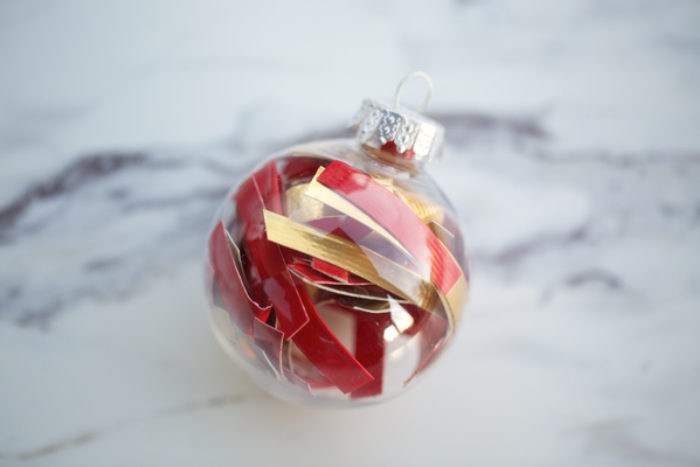 A clear ball ornament filled with Colored Duck tape.