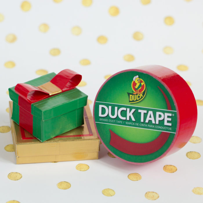 Small gifts wrapped with red colored Duck Tape, next to a roll of Duck Tape.