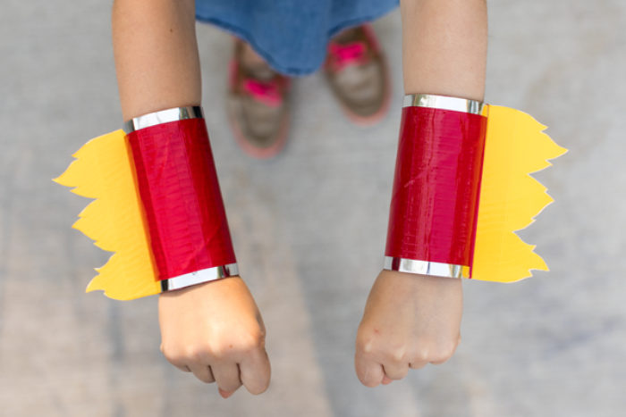 TP wrist cuffs decorated with yellow and red colored duck tape.