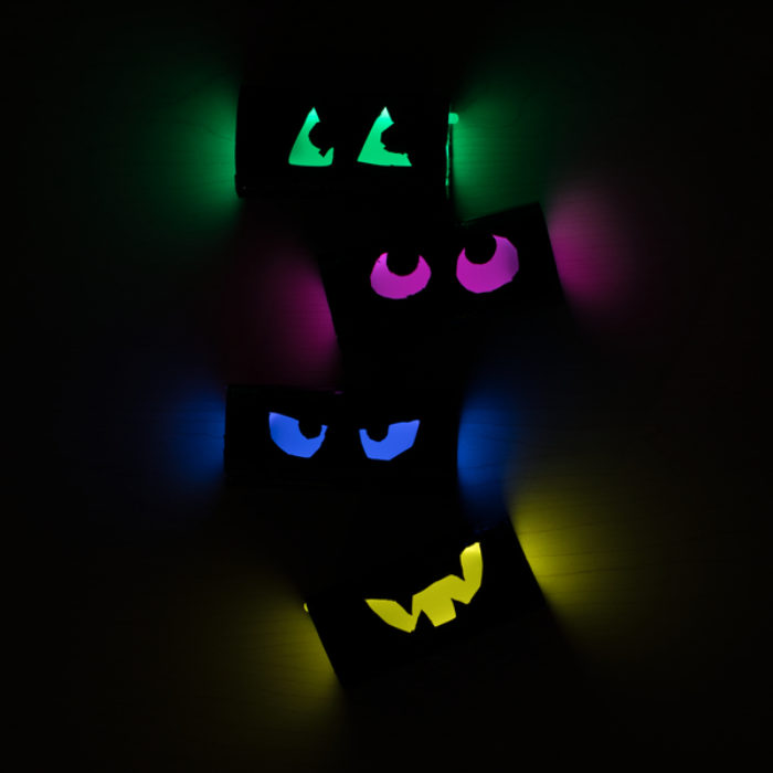 TP rolls with cut out eyes that are glowing.