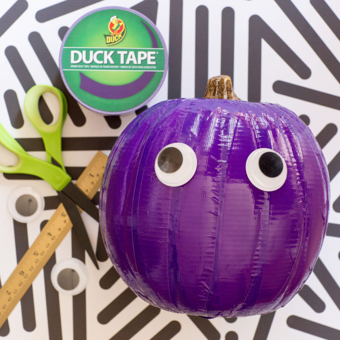 Colorful purple Duck tape over a pumpkin