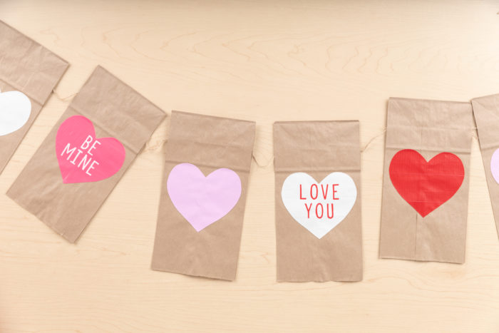 Garland made of paper bags with Duck Tape hearts on them