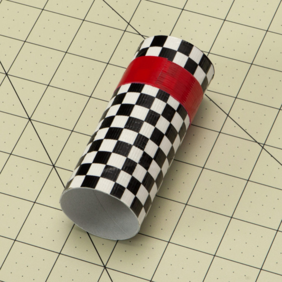 Duck Taped cardboard tube with a red strip added to the top half