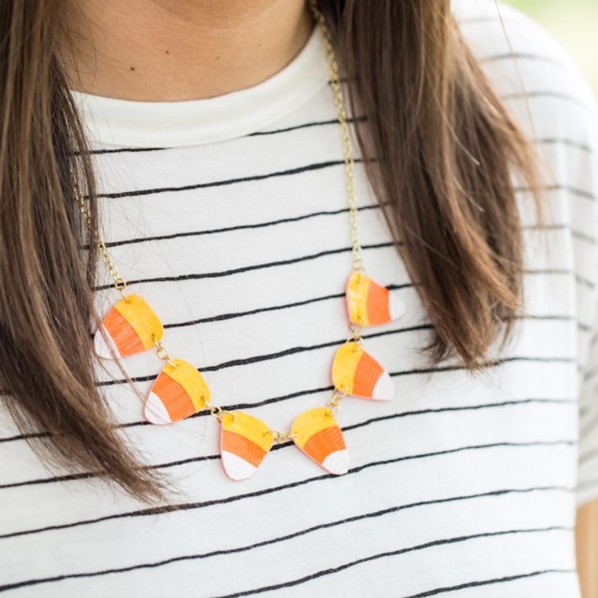 Girl wearing a completed Duck Tape® Candy Corn Necklace
