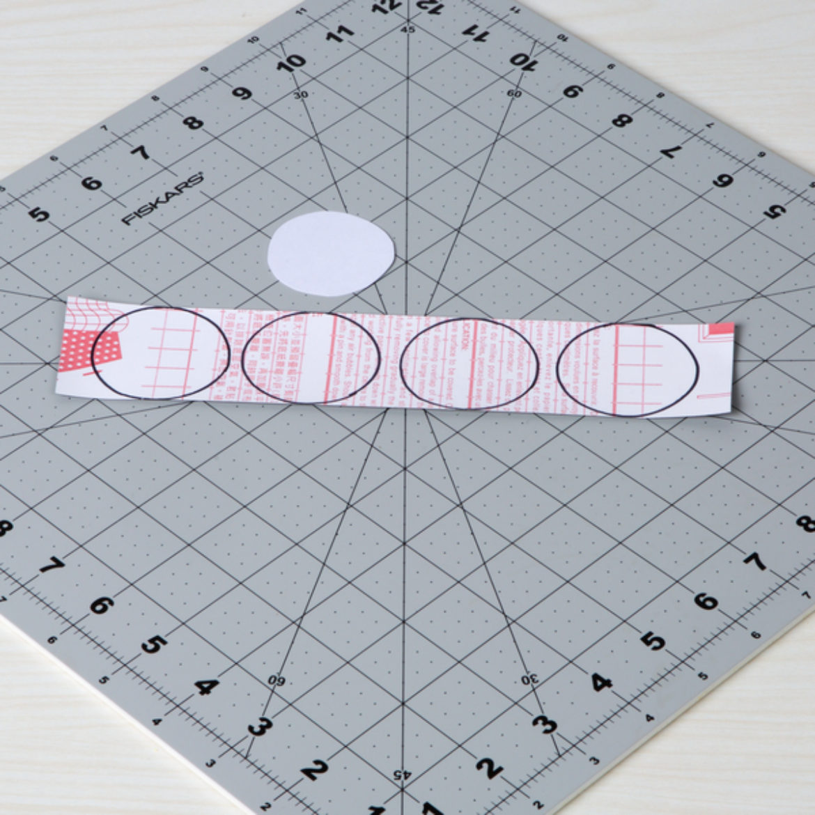 Circles traced on the back of chalkboard tape using the template made in the previous step