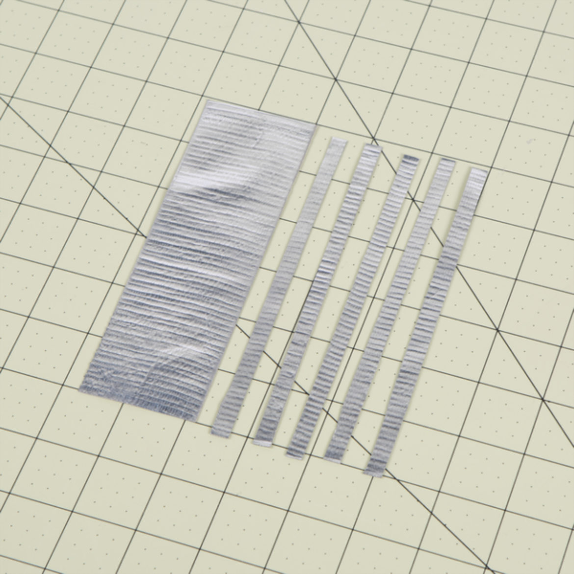 Strip of tape folded over itself length wise and cut into thin strips