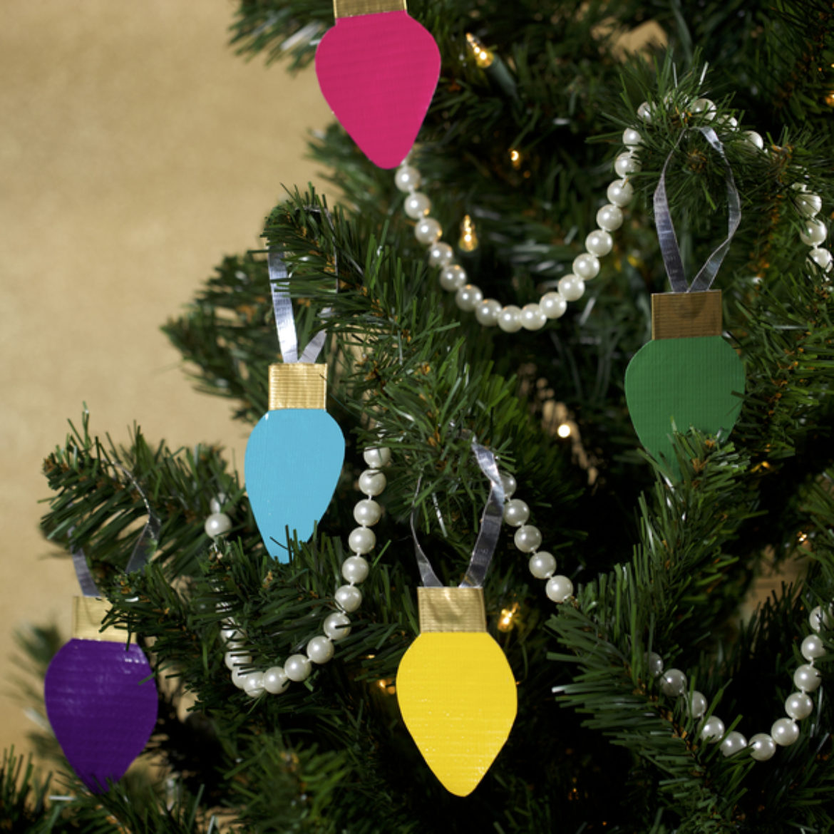 Completed  Duck Tape® Christmas Light Tree Décor hanging on a tree
