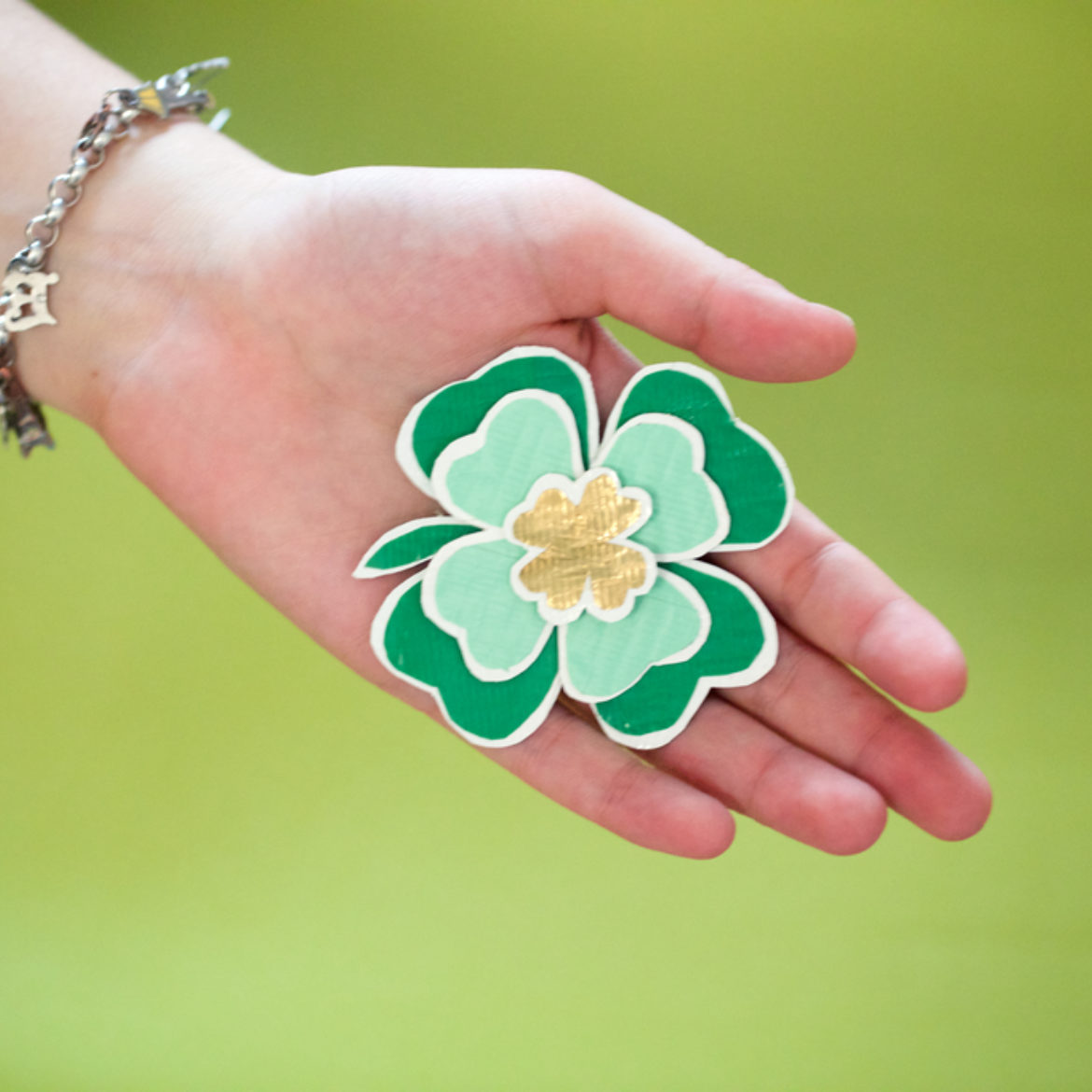 Woman holding a completed Duck Tape® Clover Magnet