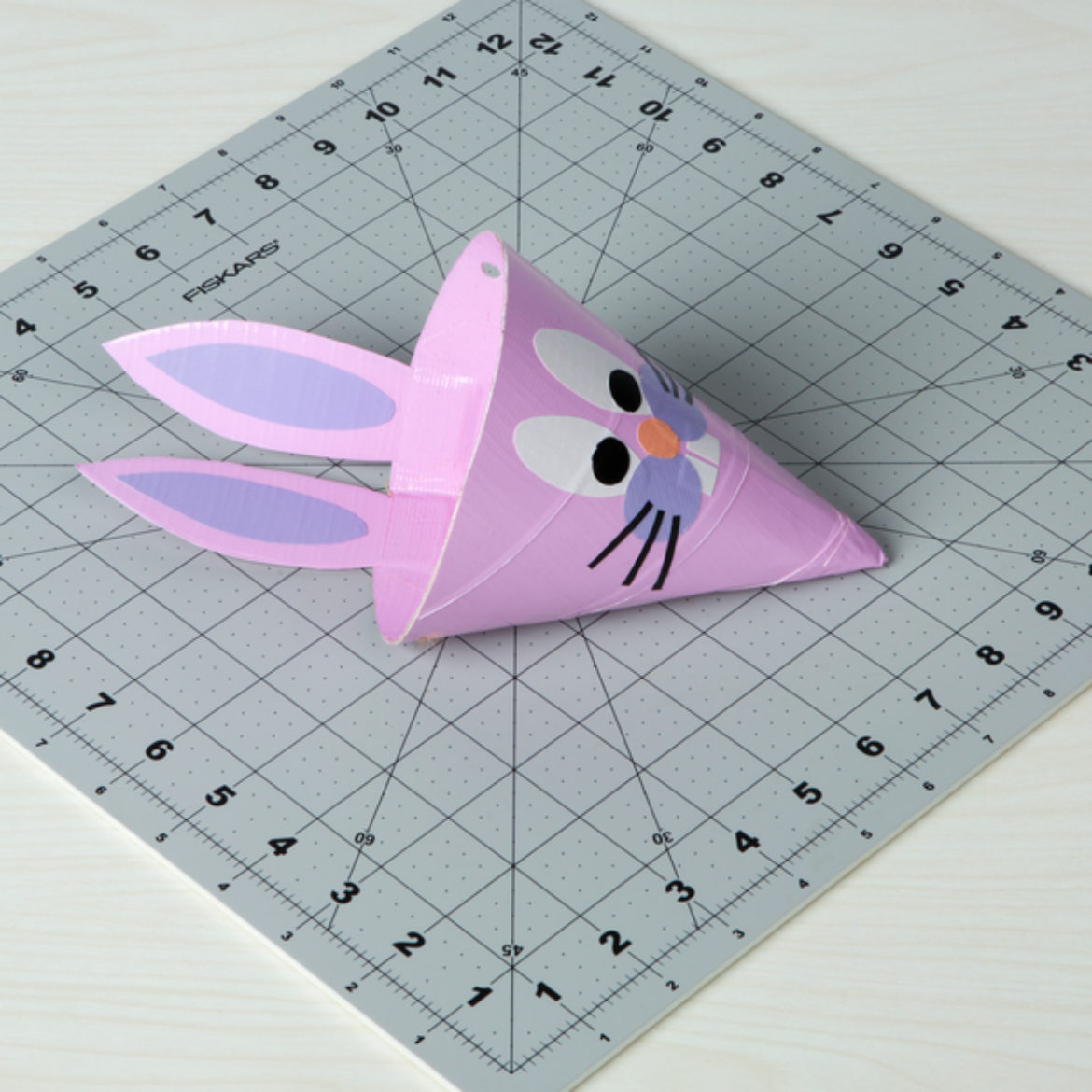 place all facial features on the cone, and attach the ears to the backside of the cone