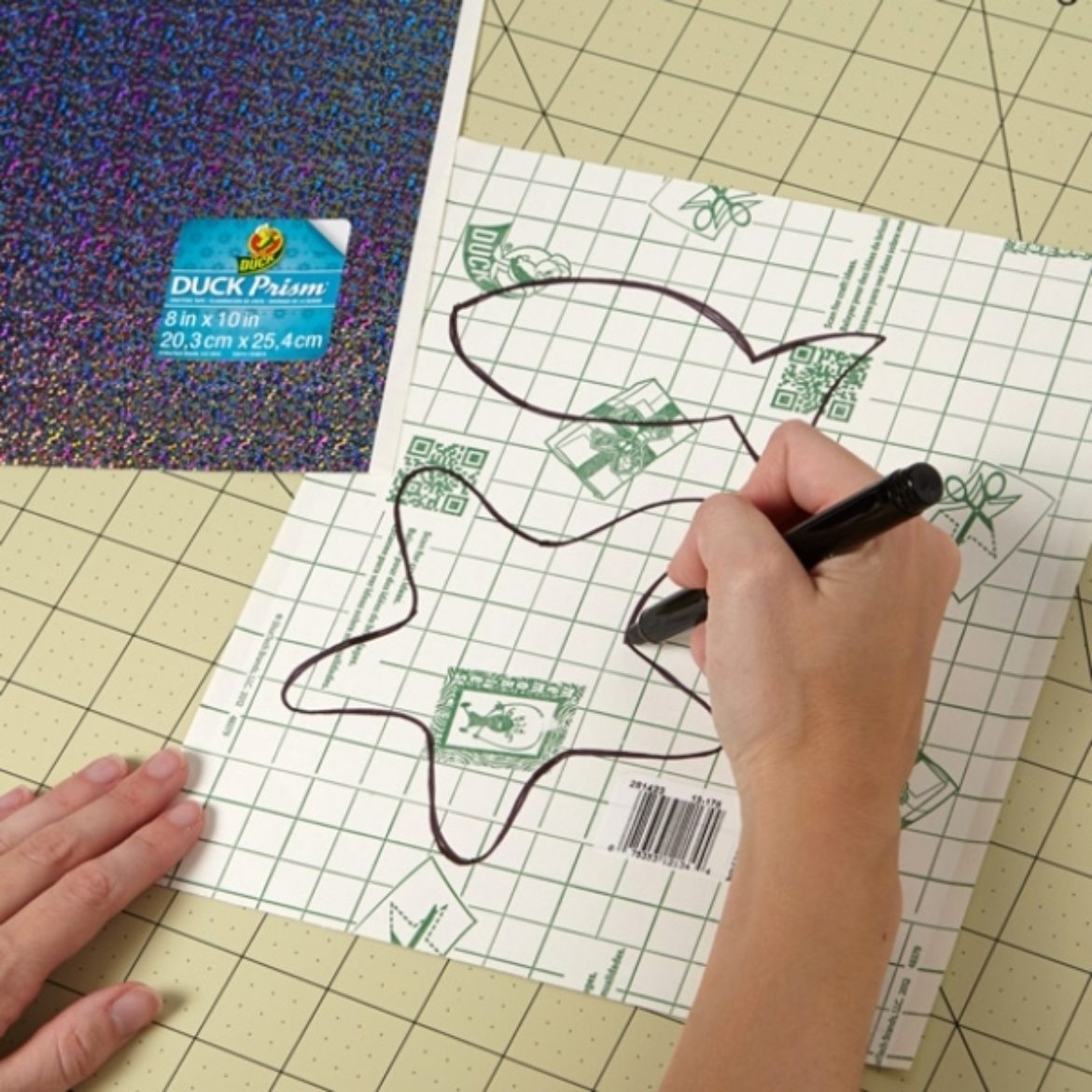 Fish shapes being drawn on the backing of Duck Prism sheets