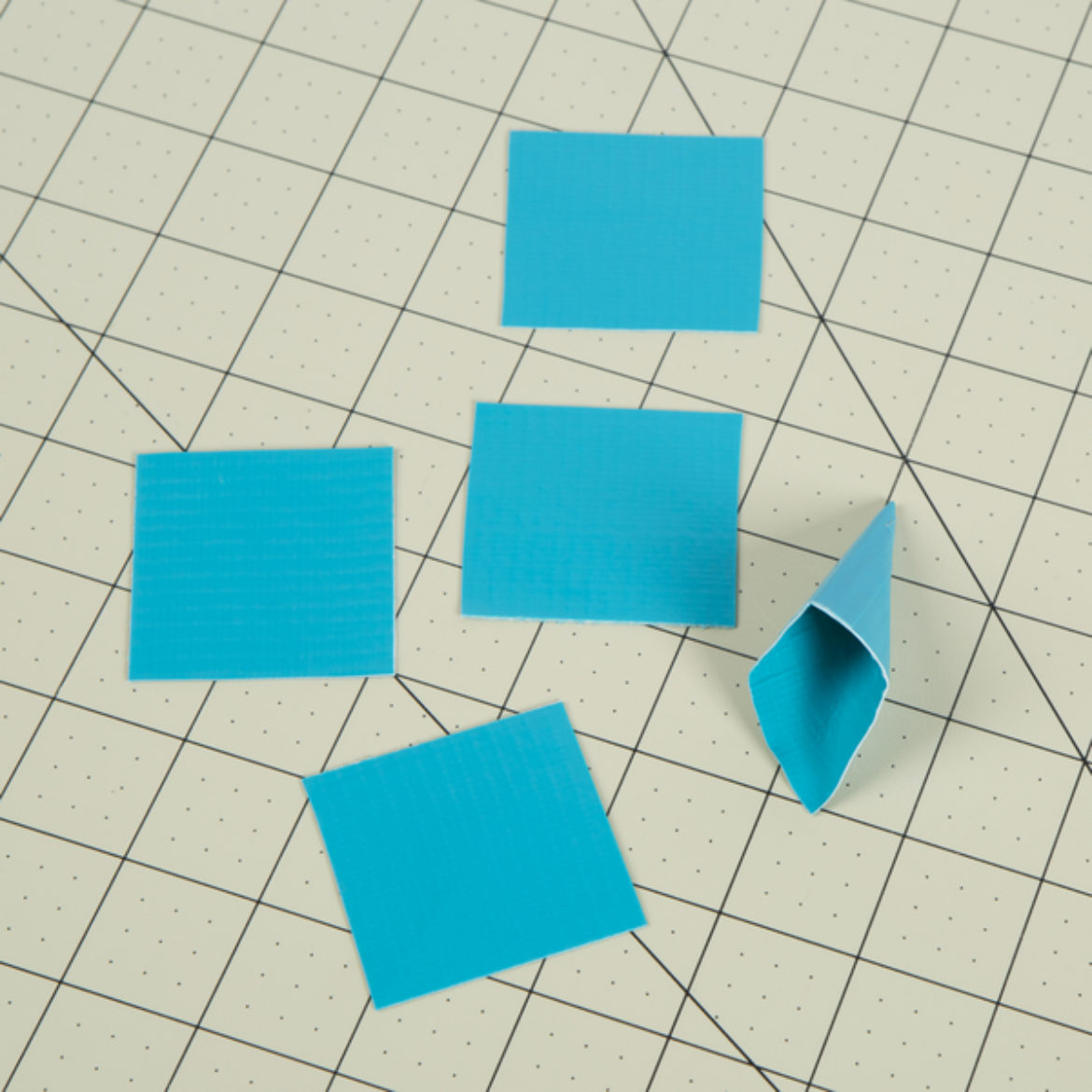 Squares from previous step folded into a cone shap and held in place with a small piece of tape