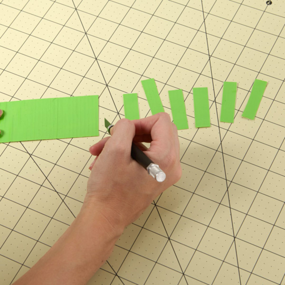 Strip of Duck Tape being cut cross-ways to create smaller strips