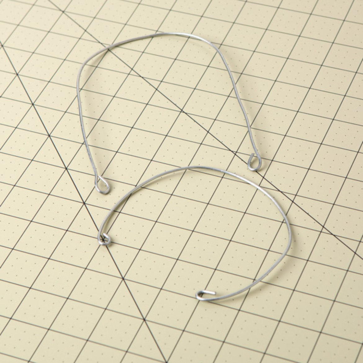 short wire bent into a u shape with loops on either end. Longer wire bent into a circular shape with the ends formed into loops