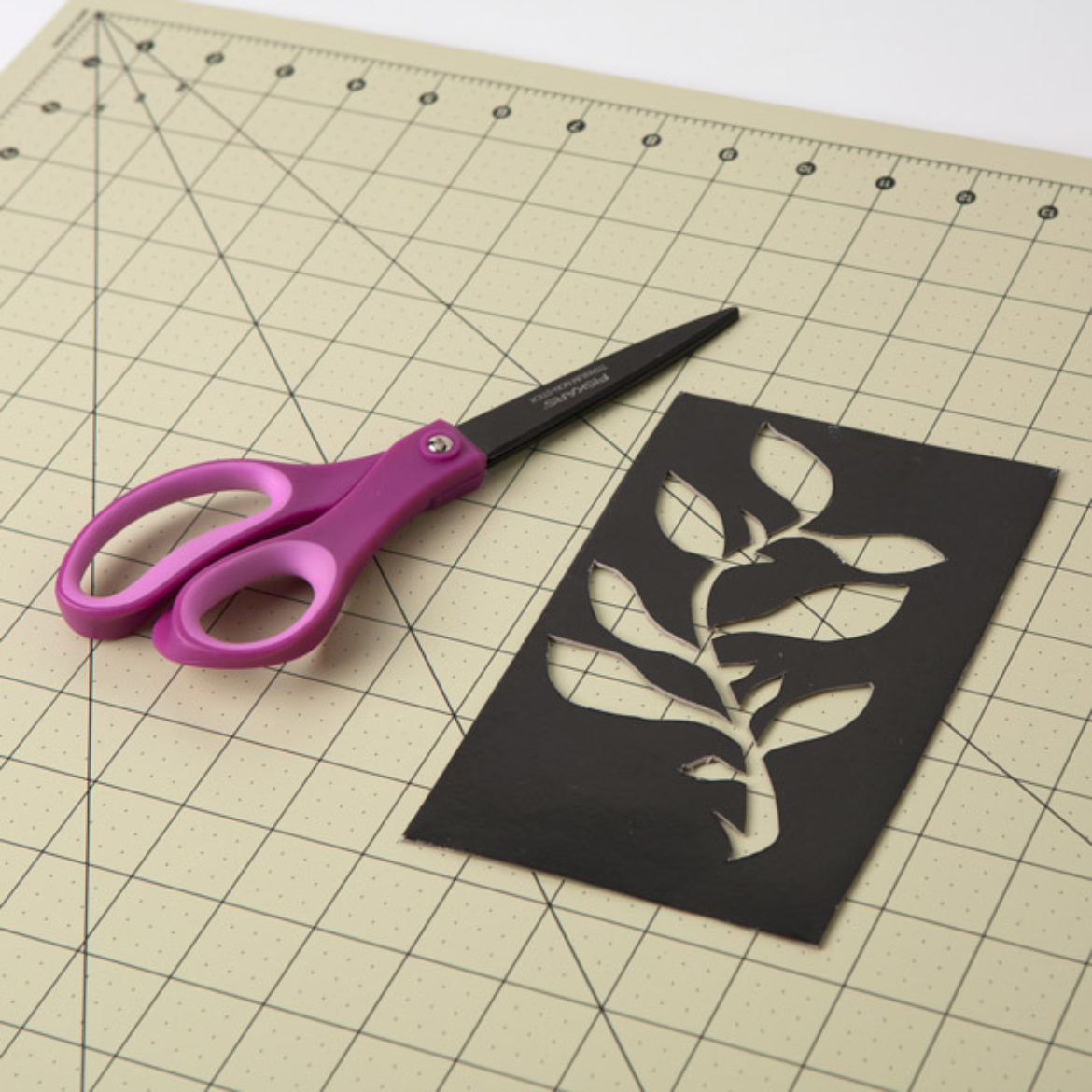 Floral design traced onto cardstock and cut out with scissors to serve as a template