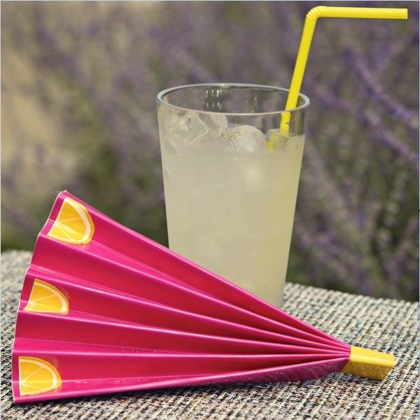 Completed Duck Tape® Hand Fan placed next to a glass of lemonade