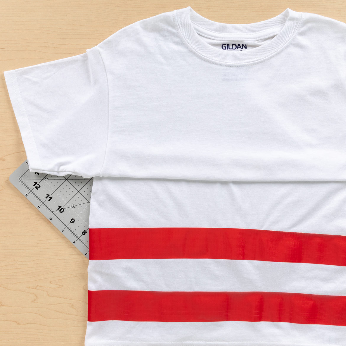 Strips of red Duck Tape attached horizontally to a white T-shirt