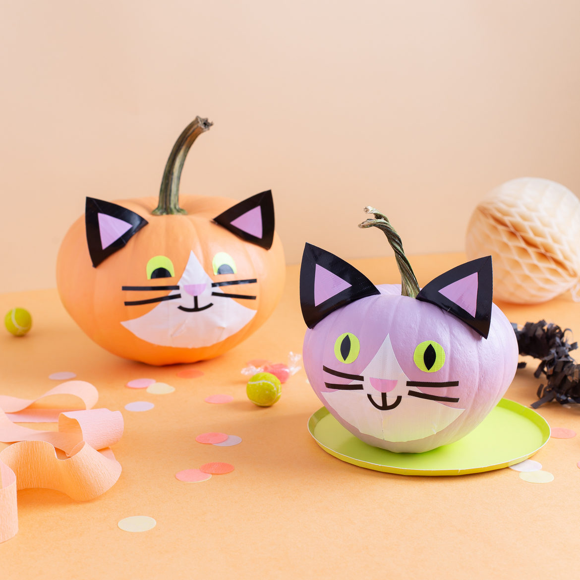 Two completed Halloween cat pumpkins with Duck Tape