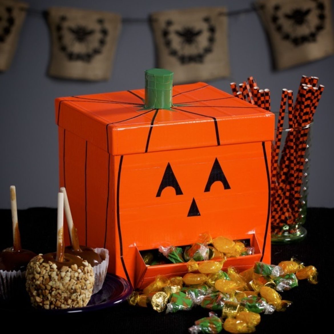 Completed Duck Tape® Pumpkin Candy Dispenser filled with candy
