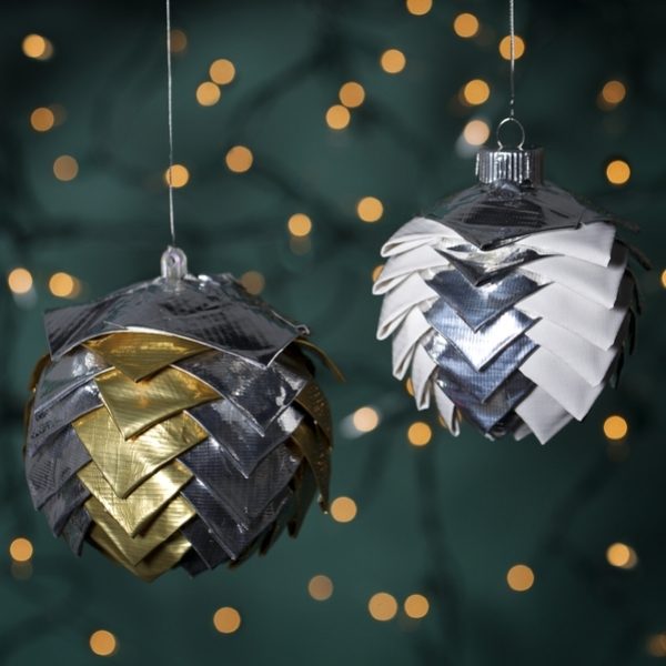Two completed Duck Tape® Scalloped Ornaments hanging from wire