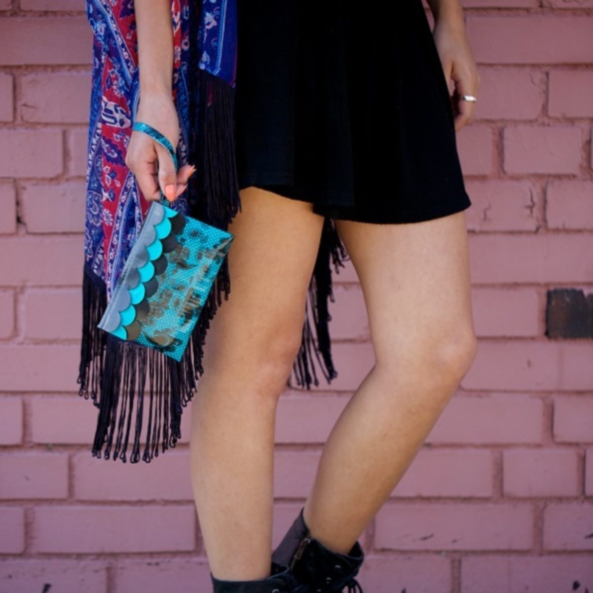 Woman holding a completed Duck Tape Scalloped Wristlet