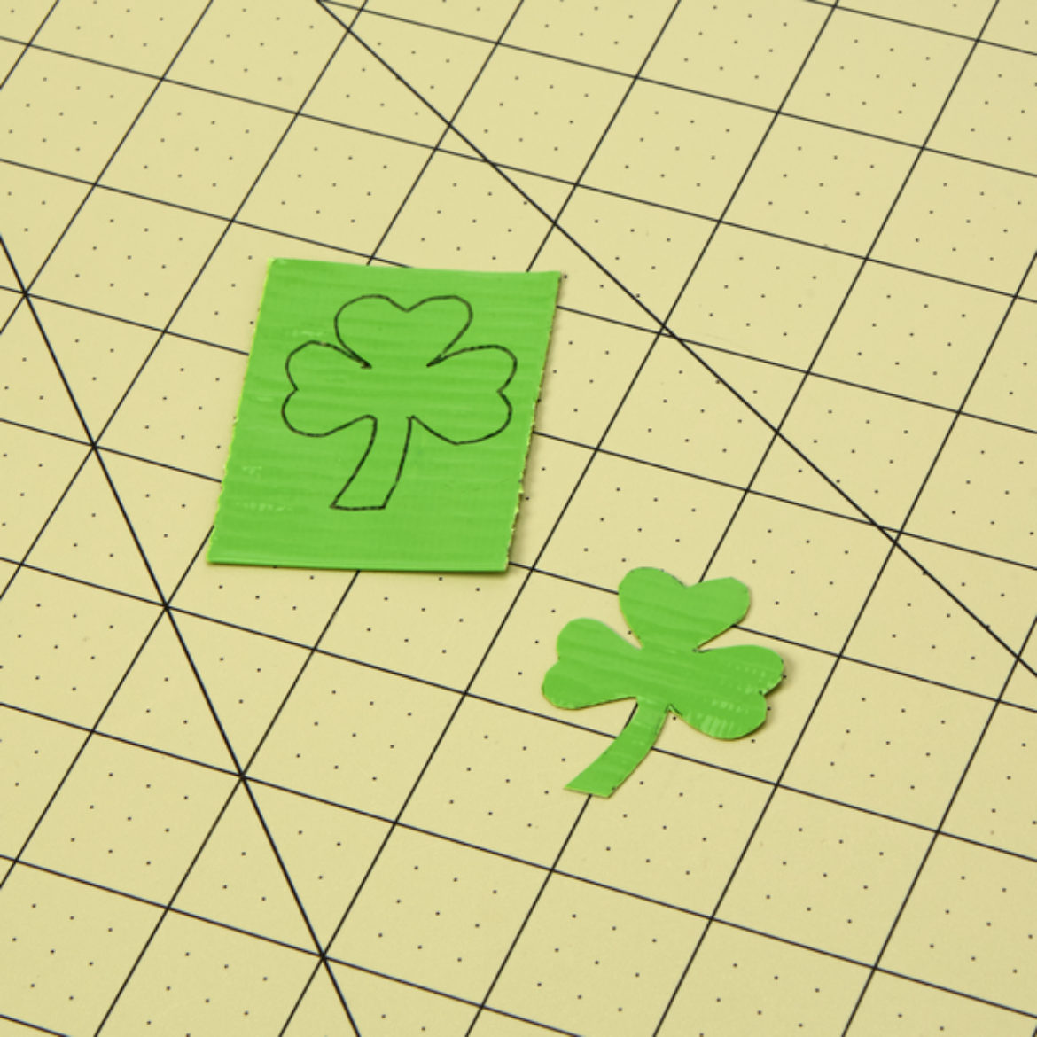 Clover shape traced onto a double piece of light green Duck Tape and cut out