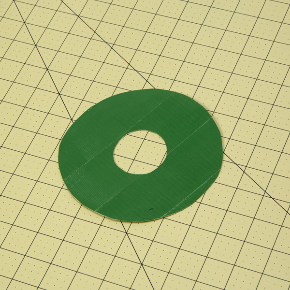 Donut shape from previous step covered in green Duck Tape