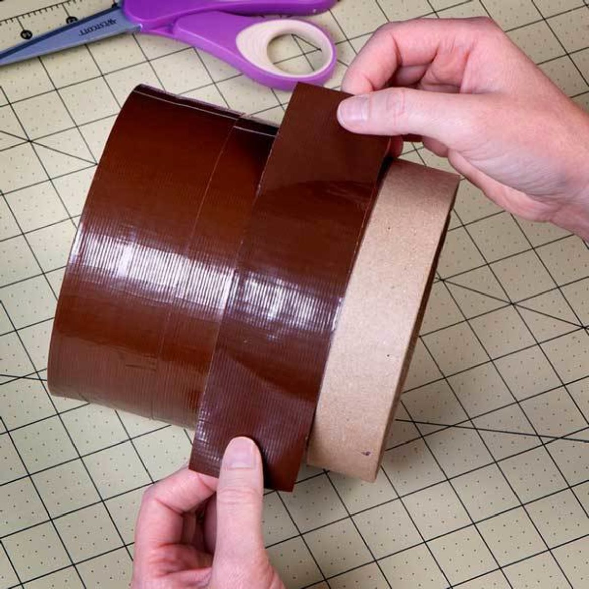 Cylinder box covered in brown Duck Tape